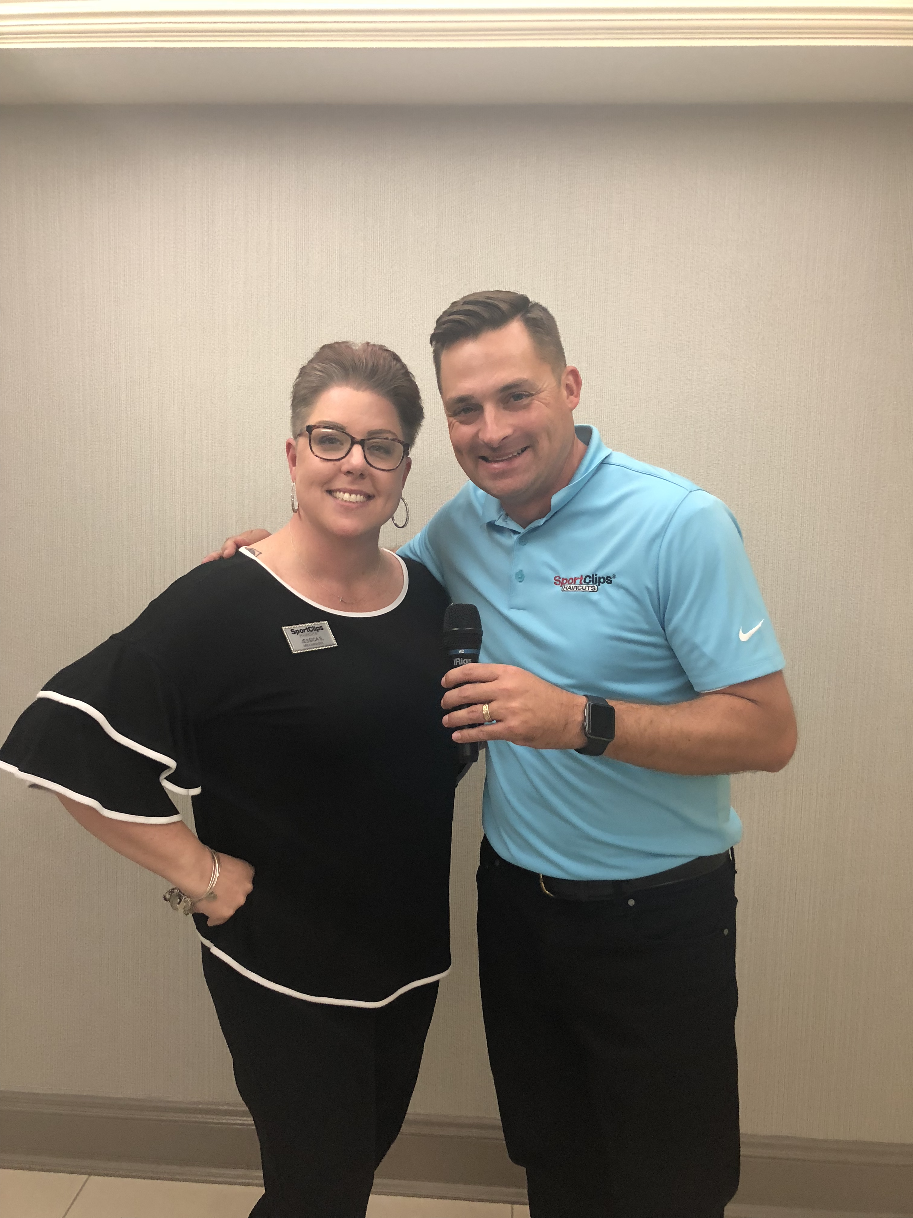 Chad Jordan and Jessica Sanders holding a microphone